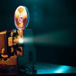 Alter Projektor mit leuchtenden Filmrollen – perfekte Darstellung für das Thema Super 8 digitalisieren